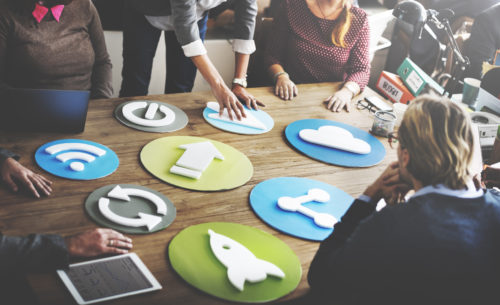 Trendy business meeting with large icons on table 