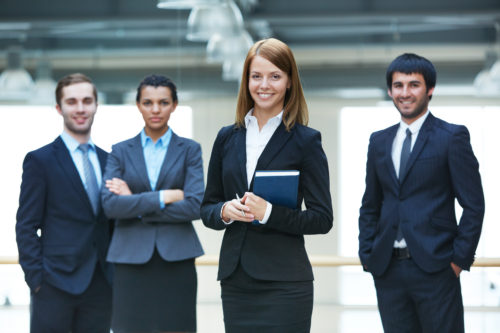 Four Young professionals smiling for a picture 