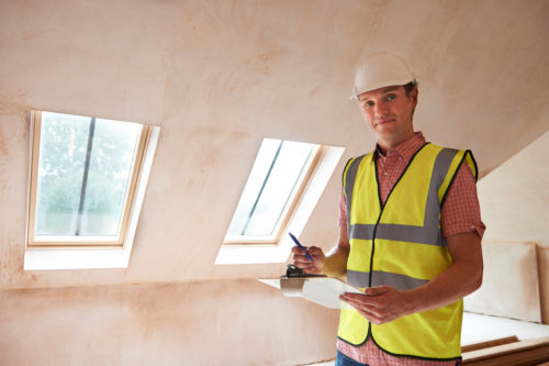 Construction worker on site with a clipboard 