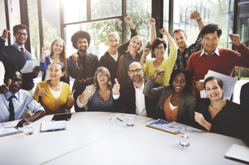 Team picture of business professionals smiling and cheering