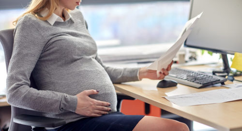 Pregnant woman at a desk 