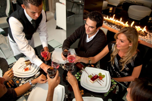 Young group of friends enjoying dinner and wine