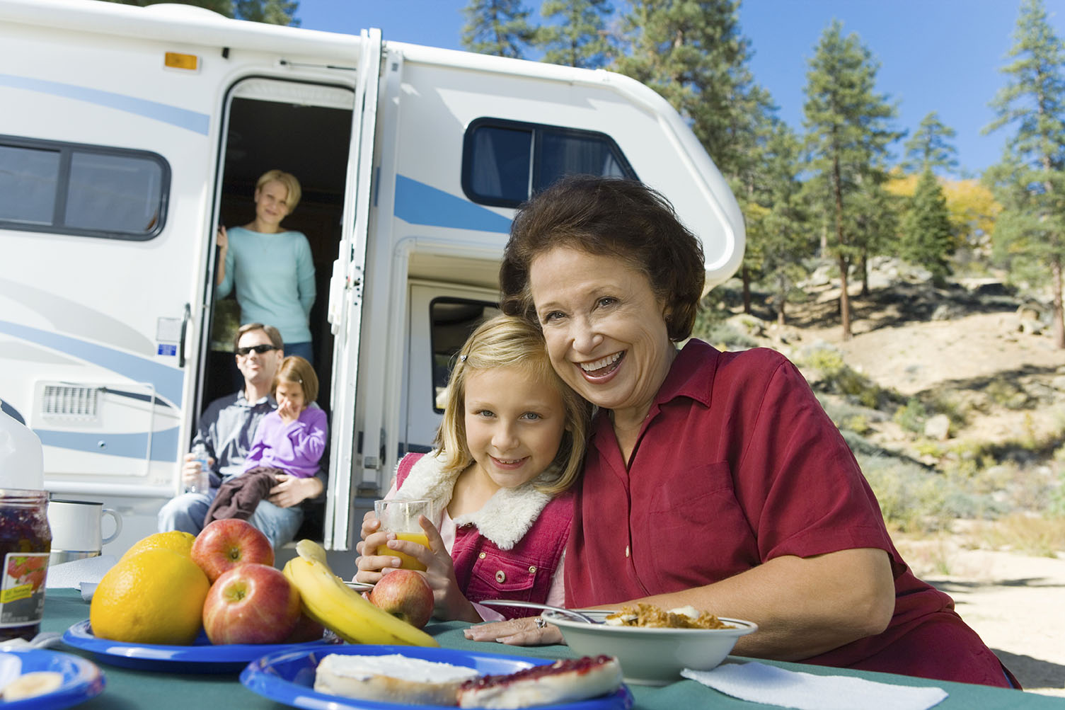 Family enjoying a camping trip with a camper