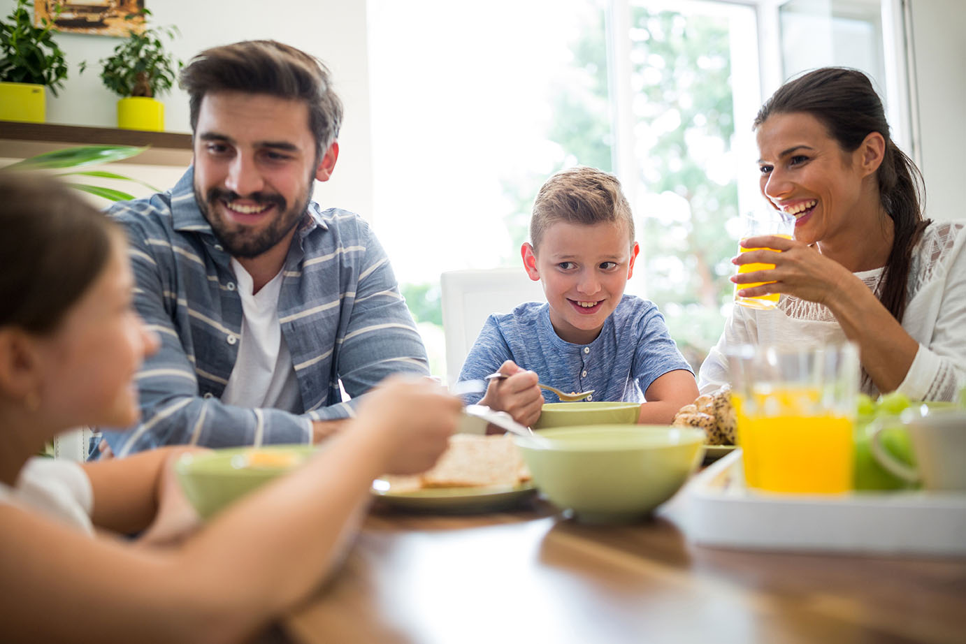 Family sitting down together for breakfast