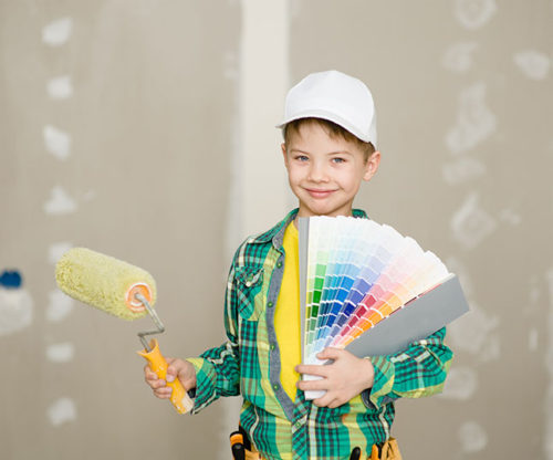 Child with paint roller and paint swatches