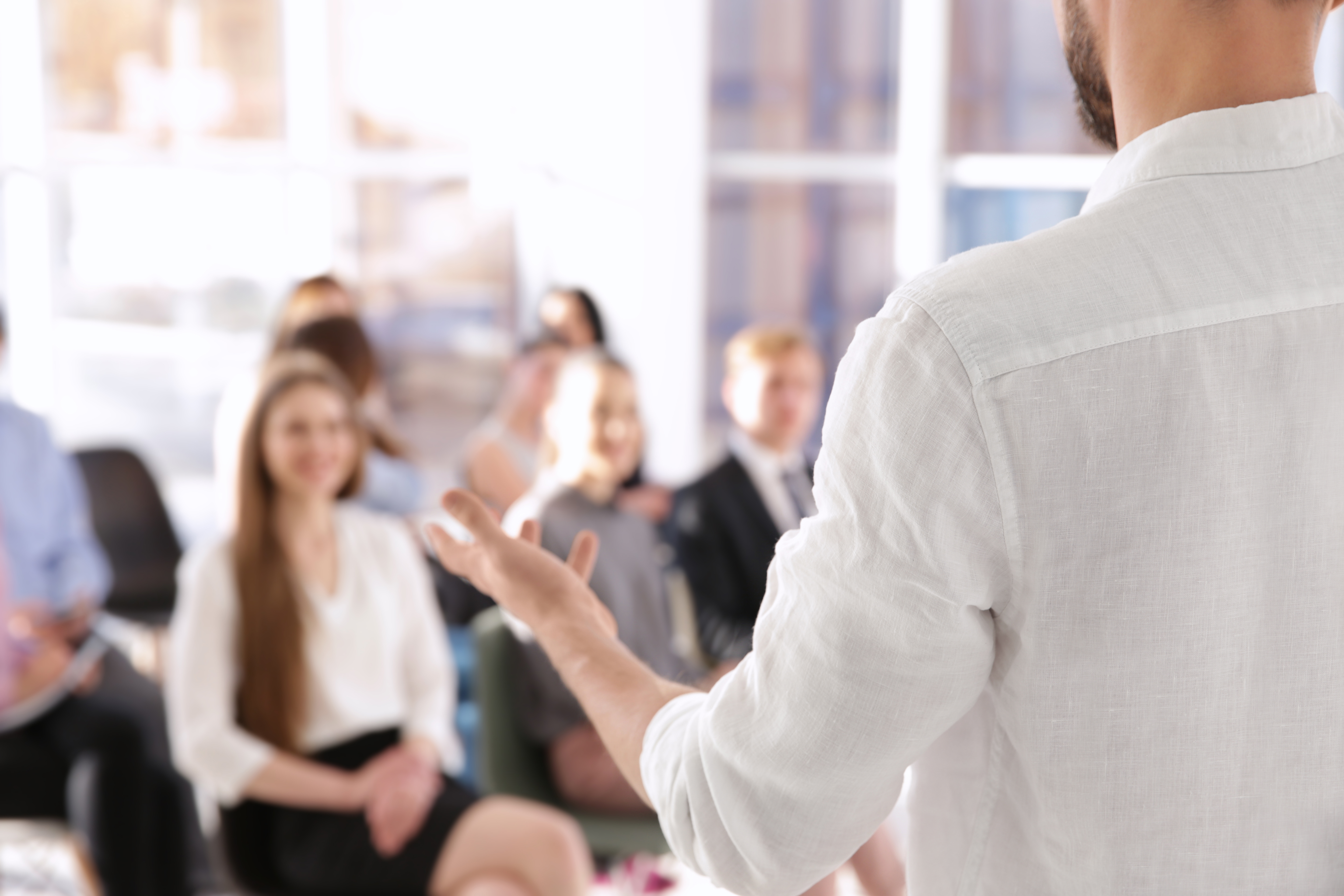 Man in professional white shirt leading a business meeting