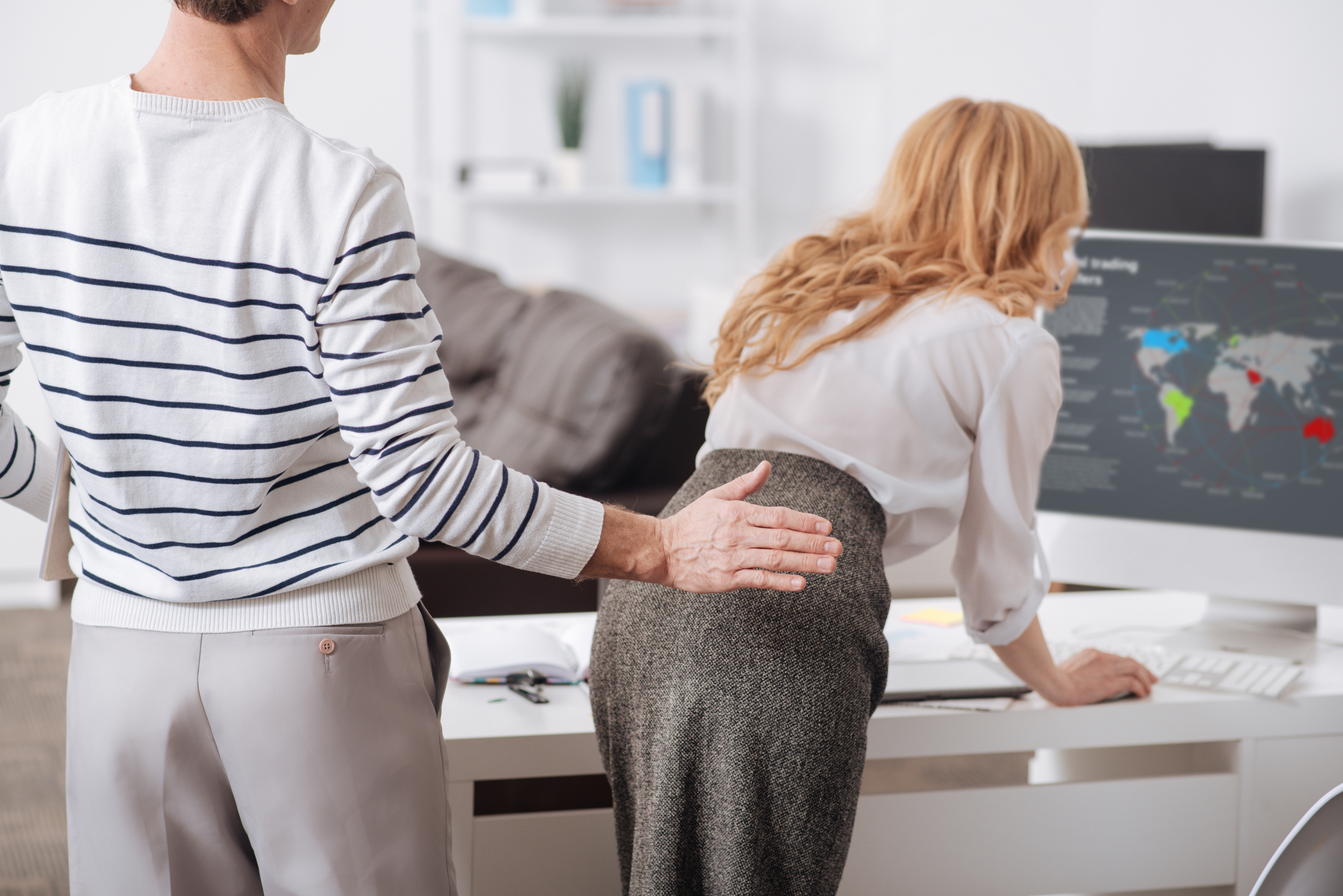 Professional man about to spank a female coworker