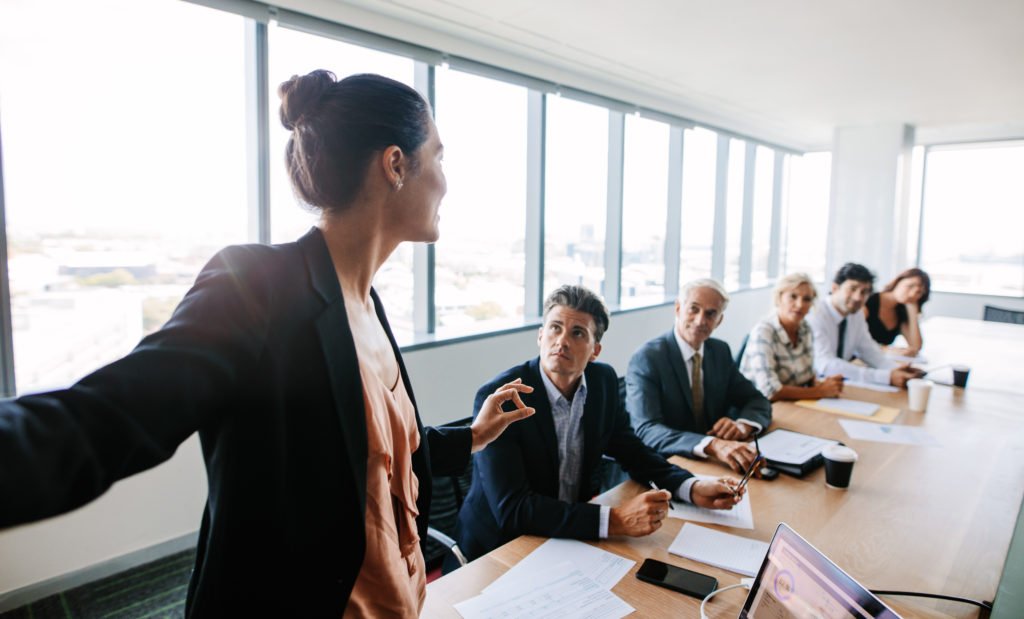 Young professional female leading a business meeting 