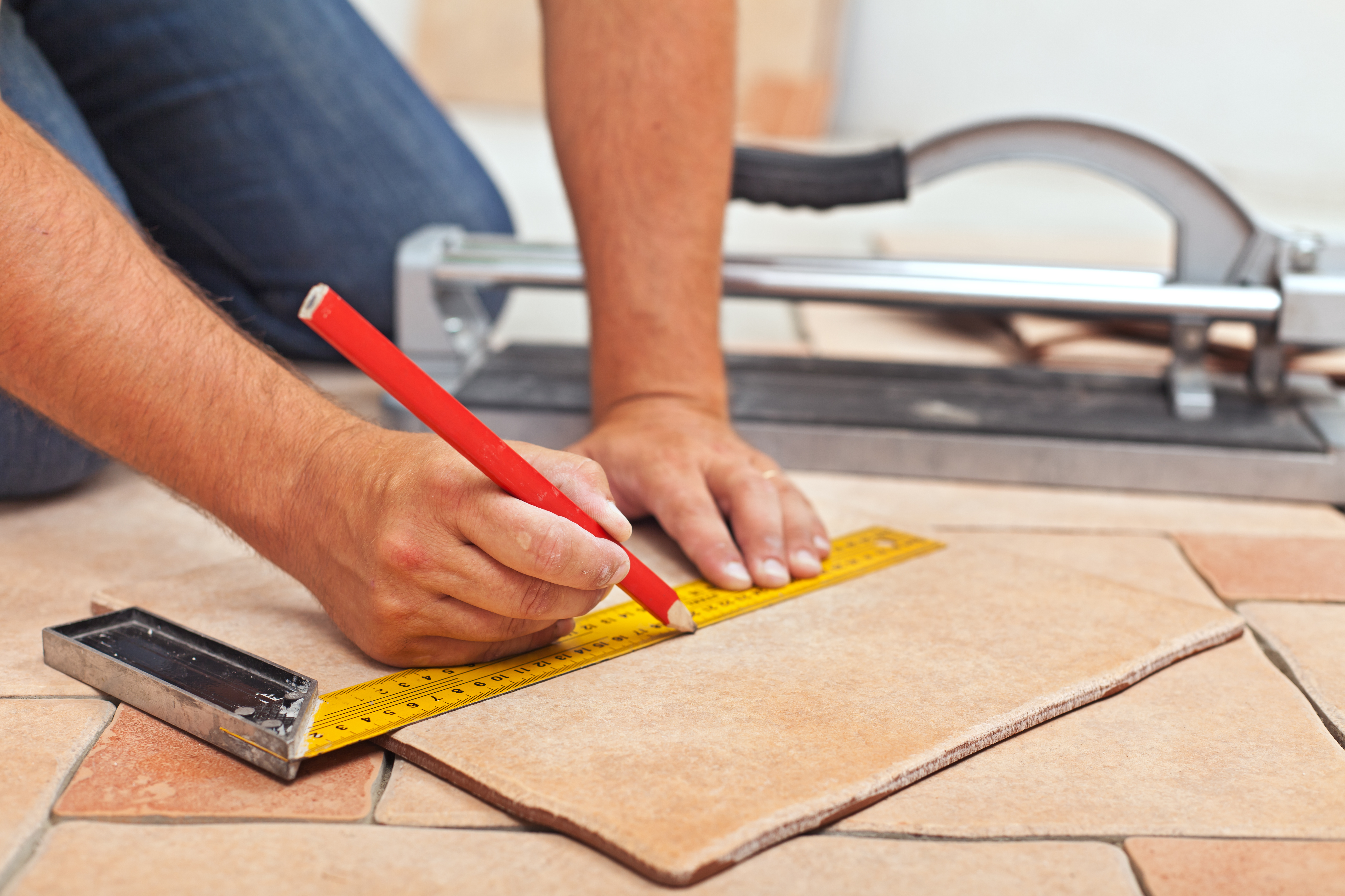 Guy measuring tile